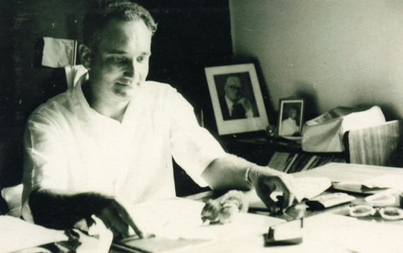 Ray Wijewardene in his study, playing with a squirrel